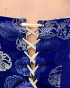 dettaglio corsetto chiusura regolabile nastro oro